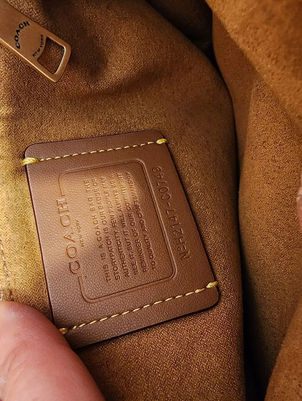 2021 Ivory Coach Beat saddle bag is crafted from glovetanned leather and brass